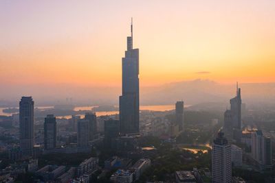 View of buildings in city during sunset