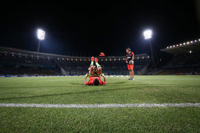 Full length of woman standing on field at night