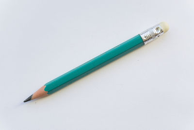 High angle view of colored pencils against white background