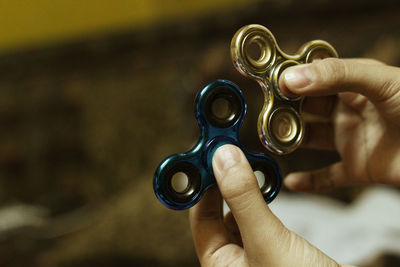 Cropped hands holding fidget spinners