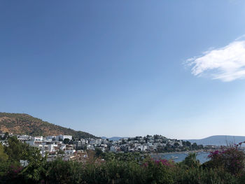 Buildings in town against blue sky