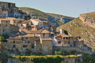 Buildings in town against clear sky