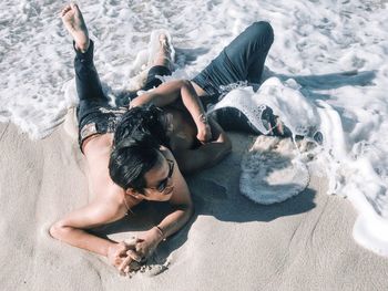 High angle view of woman lying on beach