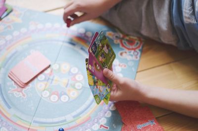 High angle view of child playing with tattoo
