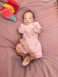 High angle view of baby boy sleeping on bed