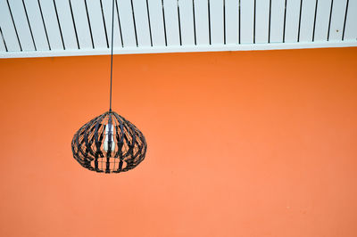 Low angle view of orange hanging on wall