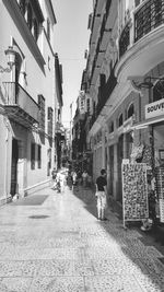 Rear view of woman walking on street in city