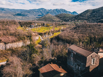 Aerial view of buildings and mountains against sky