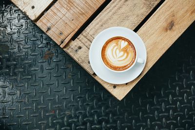 Directly above shot of cappuccino on wooden table