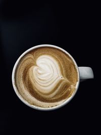 Close-up of coffee cup against black background