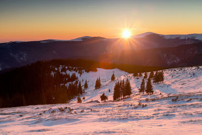 Scenic view of mountains against sky during sunset