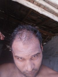 Close-up portrait of shirtless man