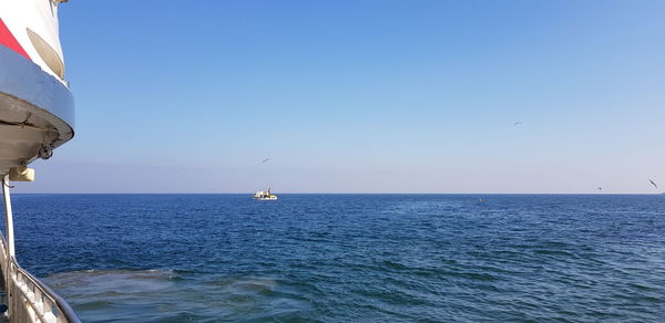 Scenic view of sea against clear blue sky