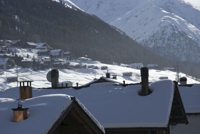 Houses on snow covered mountain