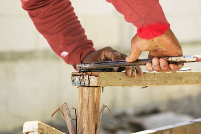 Midsection of carpenter working on wood