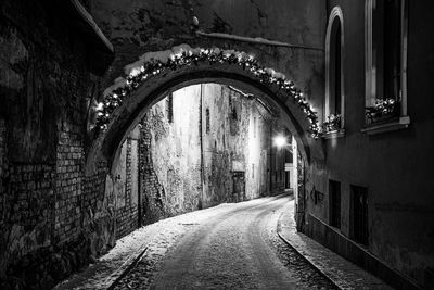 Empty alley amidst buildings in city