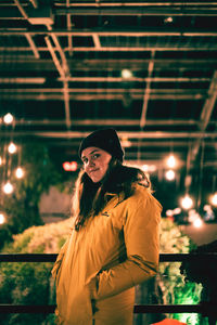 Portrait of young woman standing outdoors