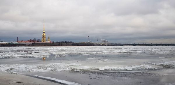 View of frozen river against cloudy sky