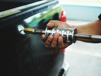 Cropped image of hand buffing car