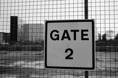 Close-up of warning sign on fence