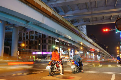 Man riding bicycle on road at night