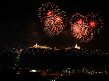 Low angle view of firework display at night