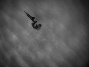 Low angle view of person paragliding against sky