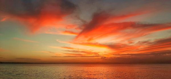 Scenic view of sea against romantic sky at sunset