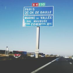 Road sign against blue sky