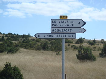 Low angle view of signboard against sky