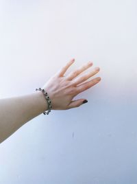 Close-up of woman hand over white background