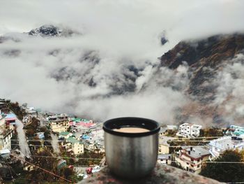 Smoke emitting from mountain against sky