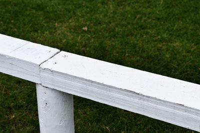 High angle view of park bench on field