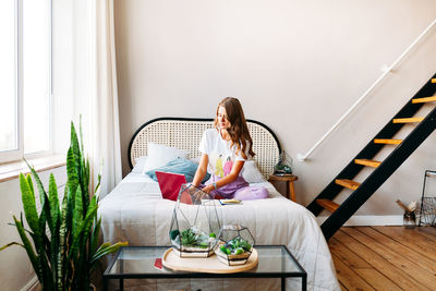 Woman sitting on sofa at home