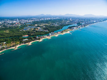 High angle view of sea and cityscape against sky