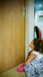 Rear view of woman sitting on chair