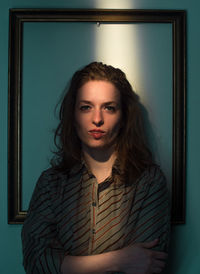 Portrait of beautiful young woman standing at home