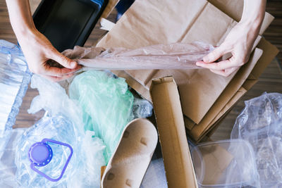 Unrecognizable woman sorting garbage. earth day concept.