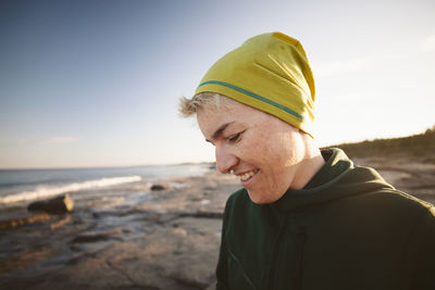 Smiling woman relaxing on coast