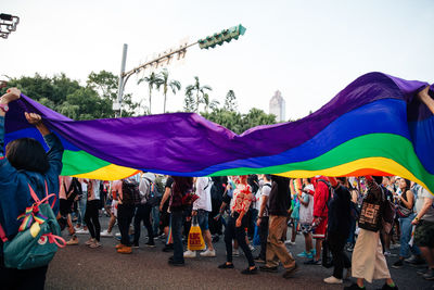 People on multi colored umbrellas against sky