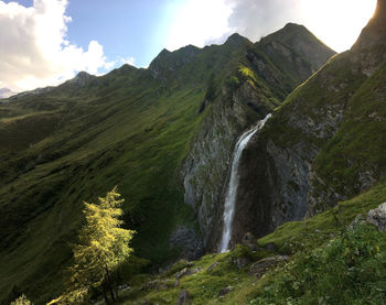 Scenic view of waterfall against sky