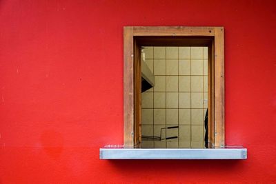 Close-up of window on red wall