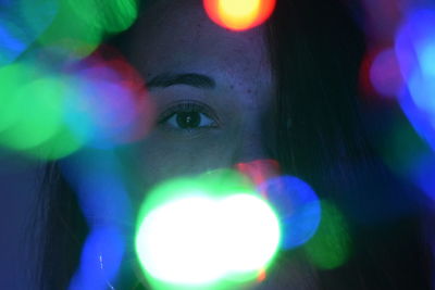 Close-up portrait of woman with colorful light painting