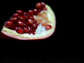 Close-up of strawberries on table against black background