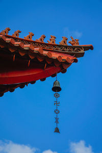 Low angle view of bell tower against blue sky