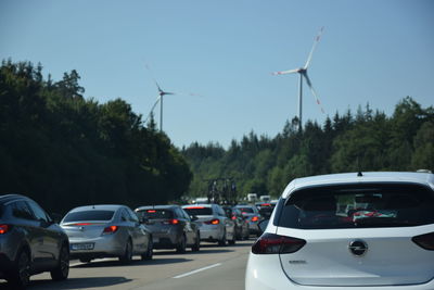 Cars on street against sky