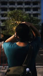 Rear view of man sitting outdoors