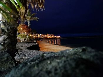 Scenic view of beach against sky at night