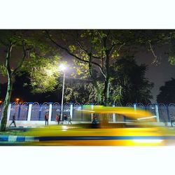 Illuminated street light against sky at night