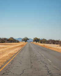 Empty road along countryside landscape